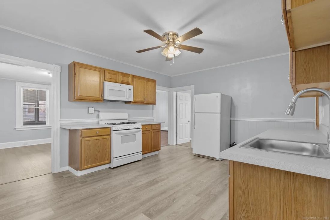 Second-unit kitchen with peninsula, tile backsplash and full appliance package in New Britain, CT