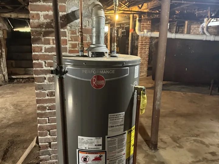Basement mechanical area with new water heater in the Norwich two-family