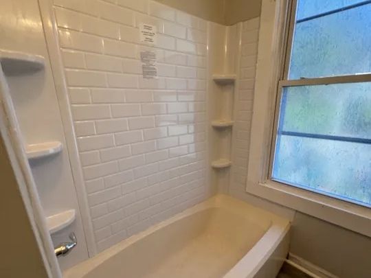 Updated bathroom with new tub and subway-tile surround in the Norwich multi-family