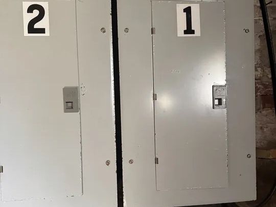 Separate electrical panels serving unit one and unit two of the Norwich, CT two-family